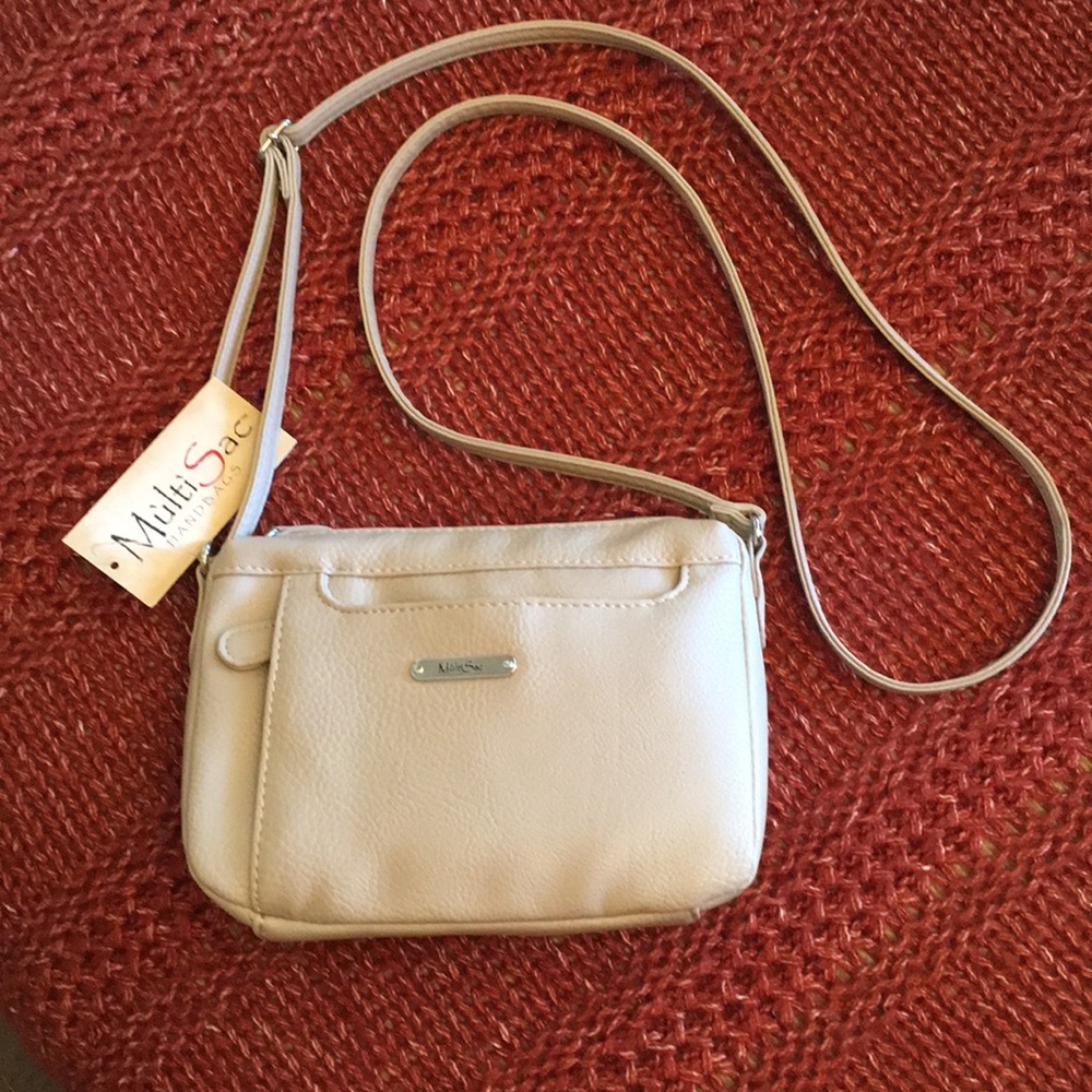 NWT adjustable crossbody handbag. Neutral beige color.